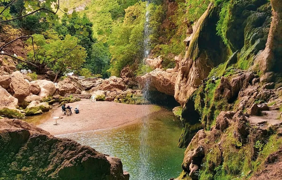 The Akchour waterfall pouring into a turquoise pool in the Rif mountains near Chefchaouen.